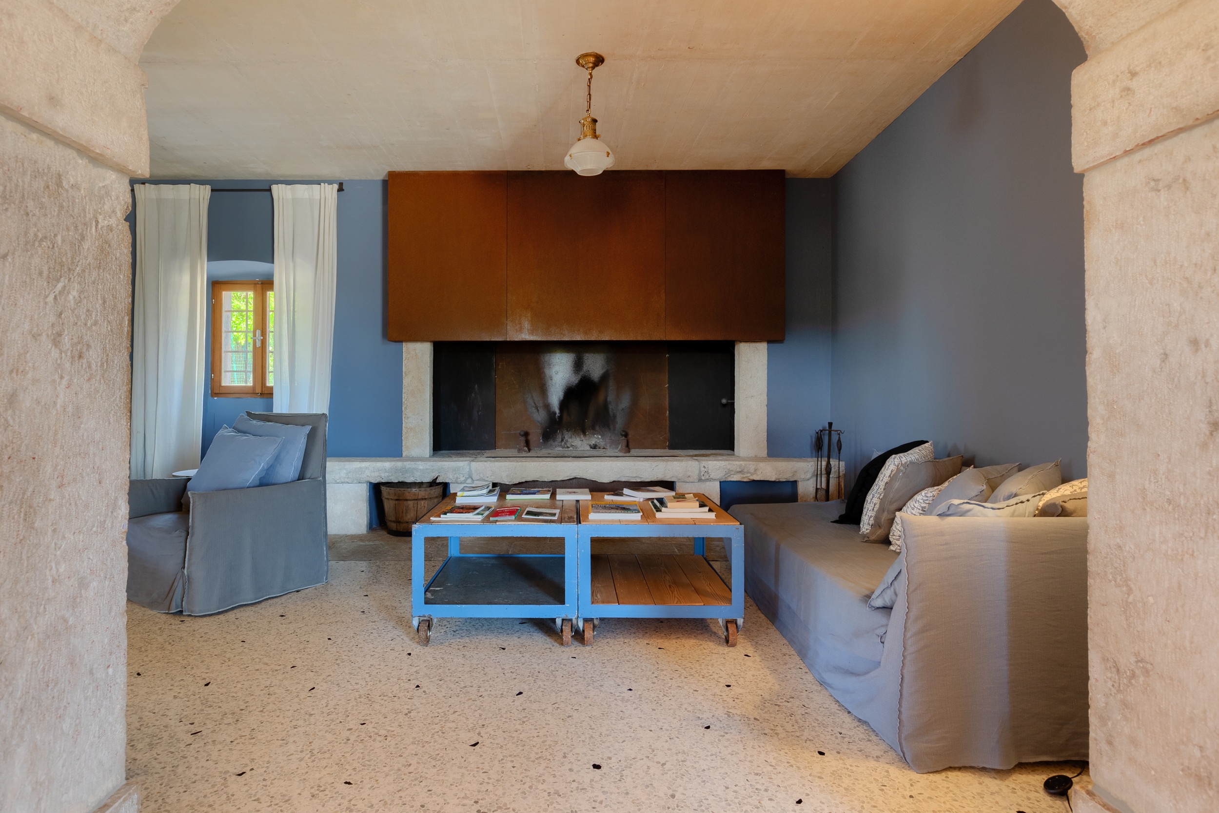 casa ceppi istria croatia interior blue living room rustic fireplace blue coffee table