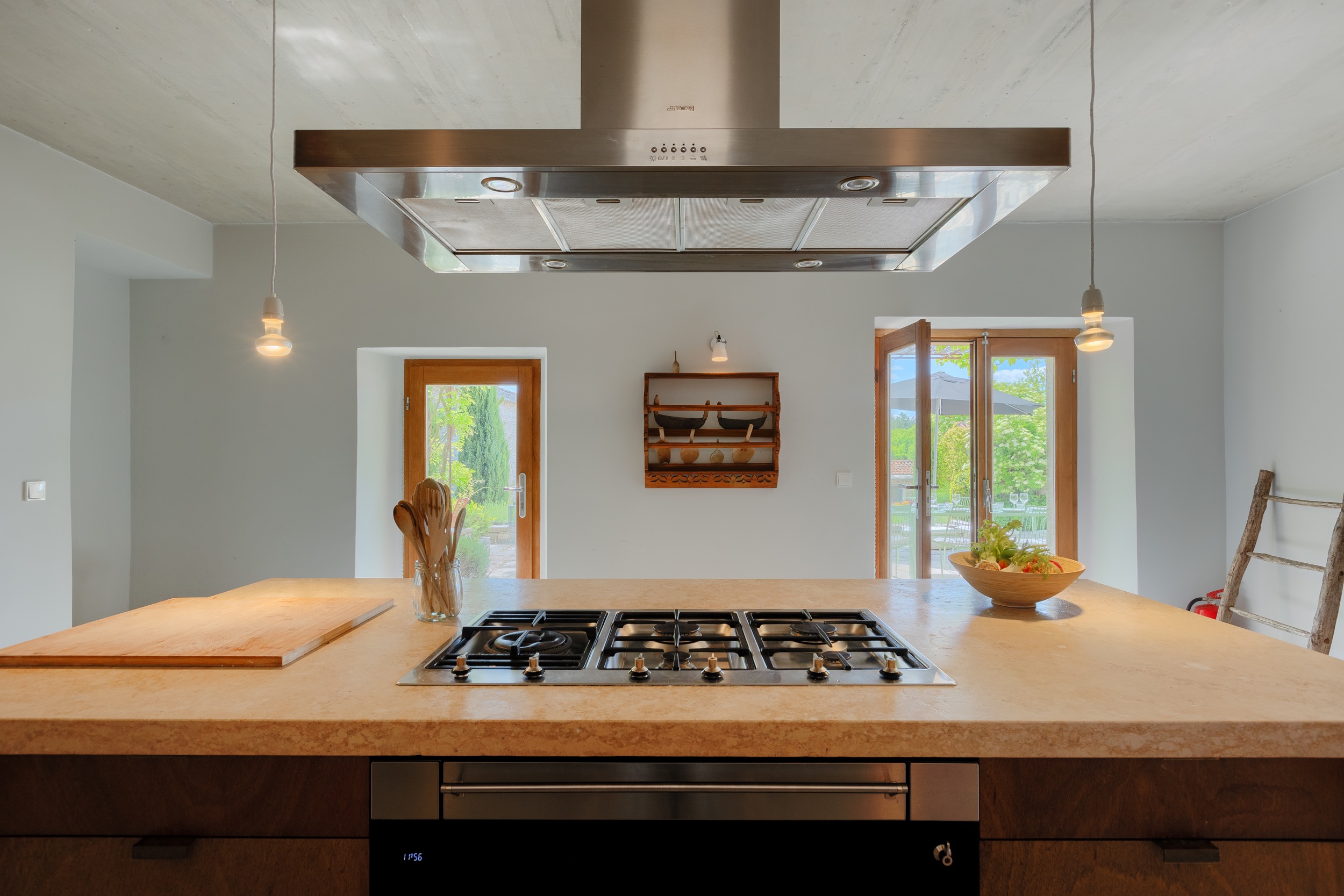 casa ceppi istria croatia interior kitchen island cooktop view double glass doors