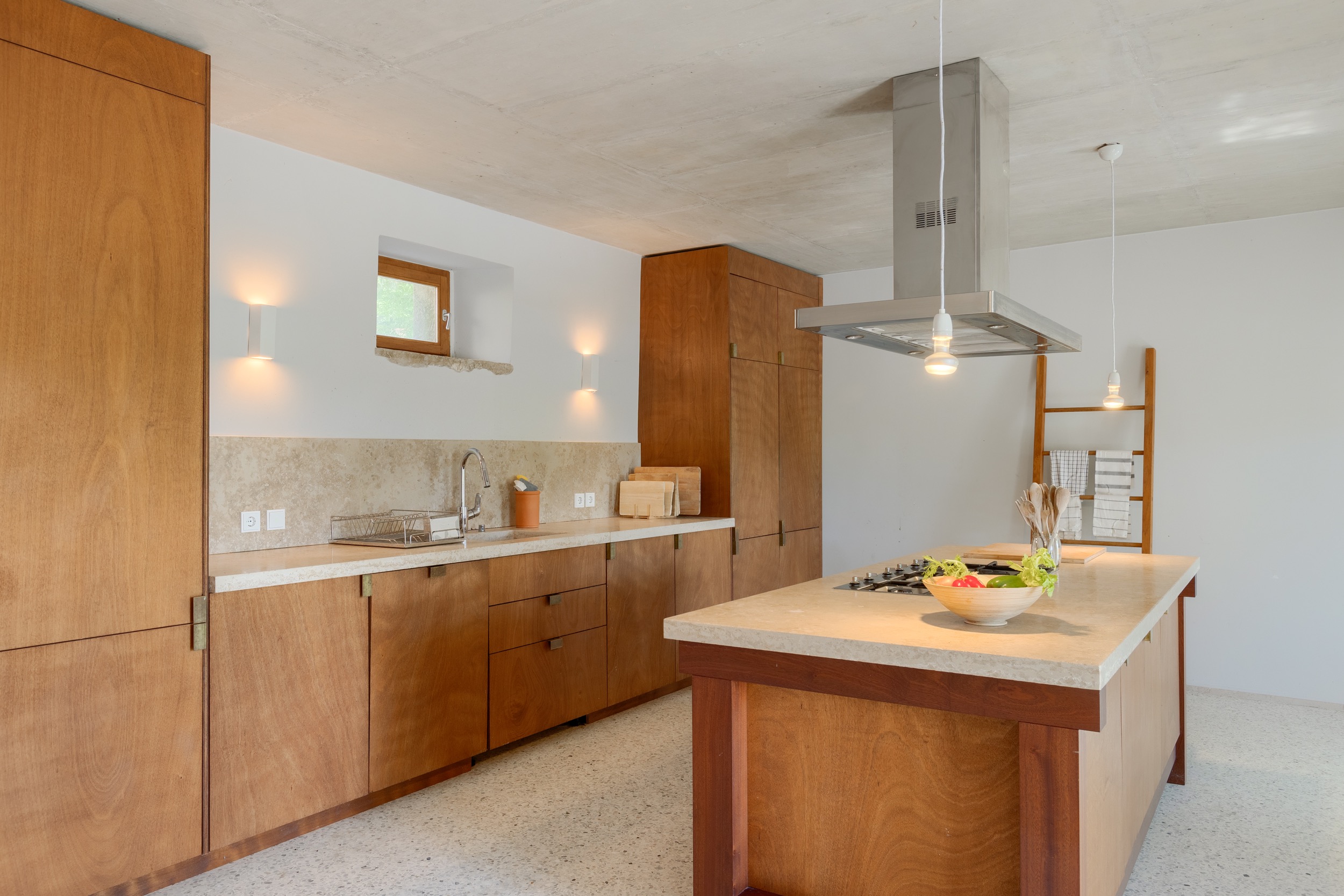 casa ceppi istria croatia interior kitchen island stainless range hood wood cabinetry