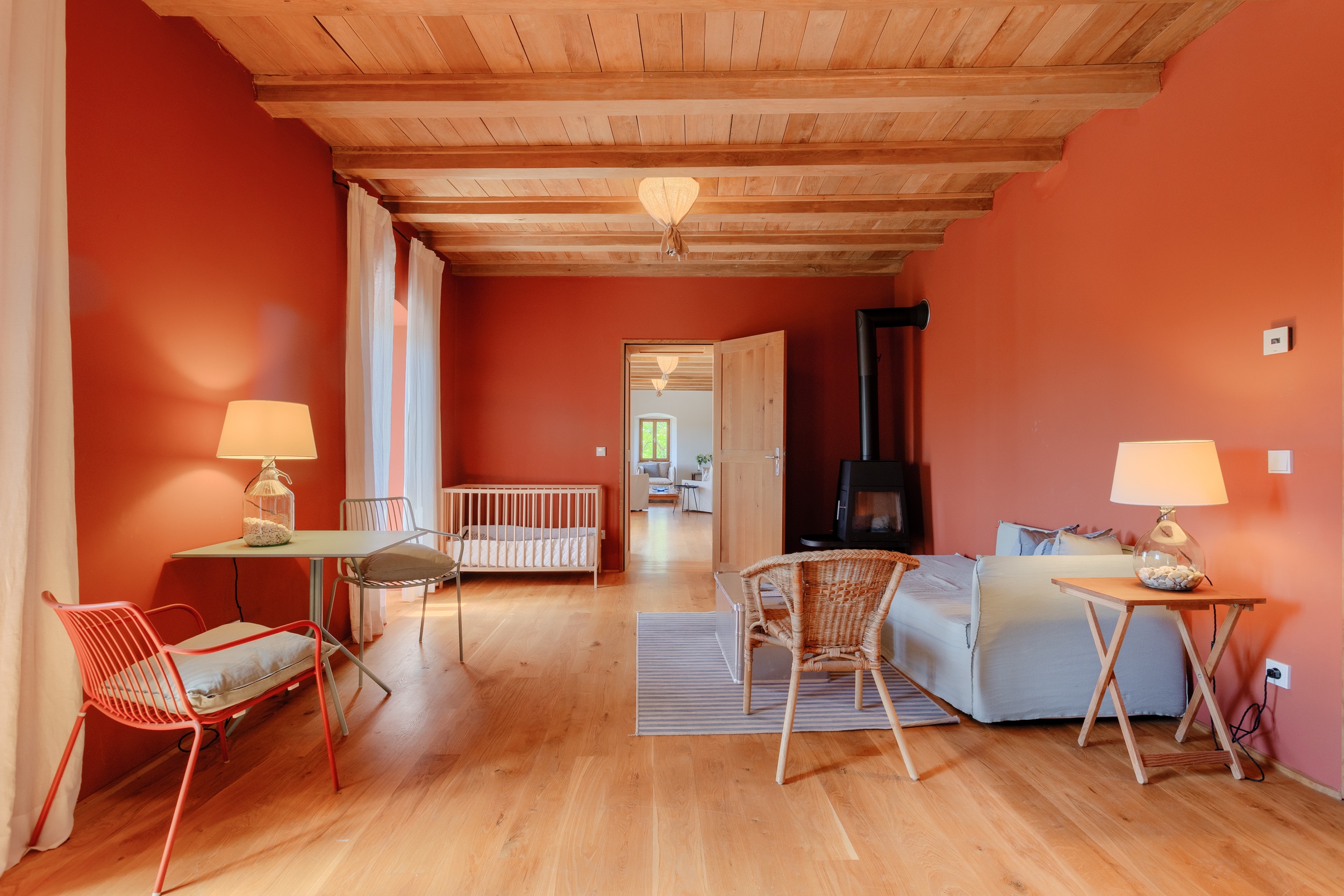 casa ceppi istria croatia interior red living room wood stove crib armchairs