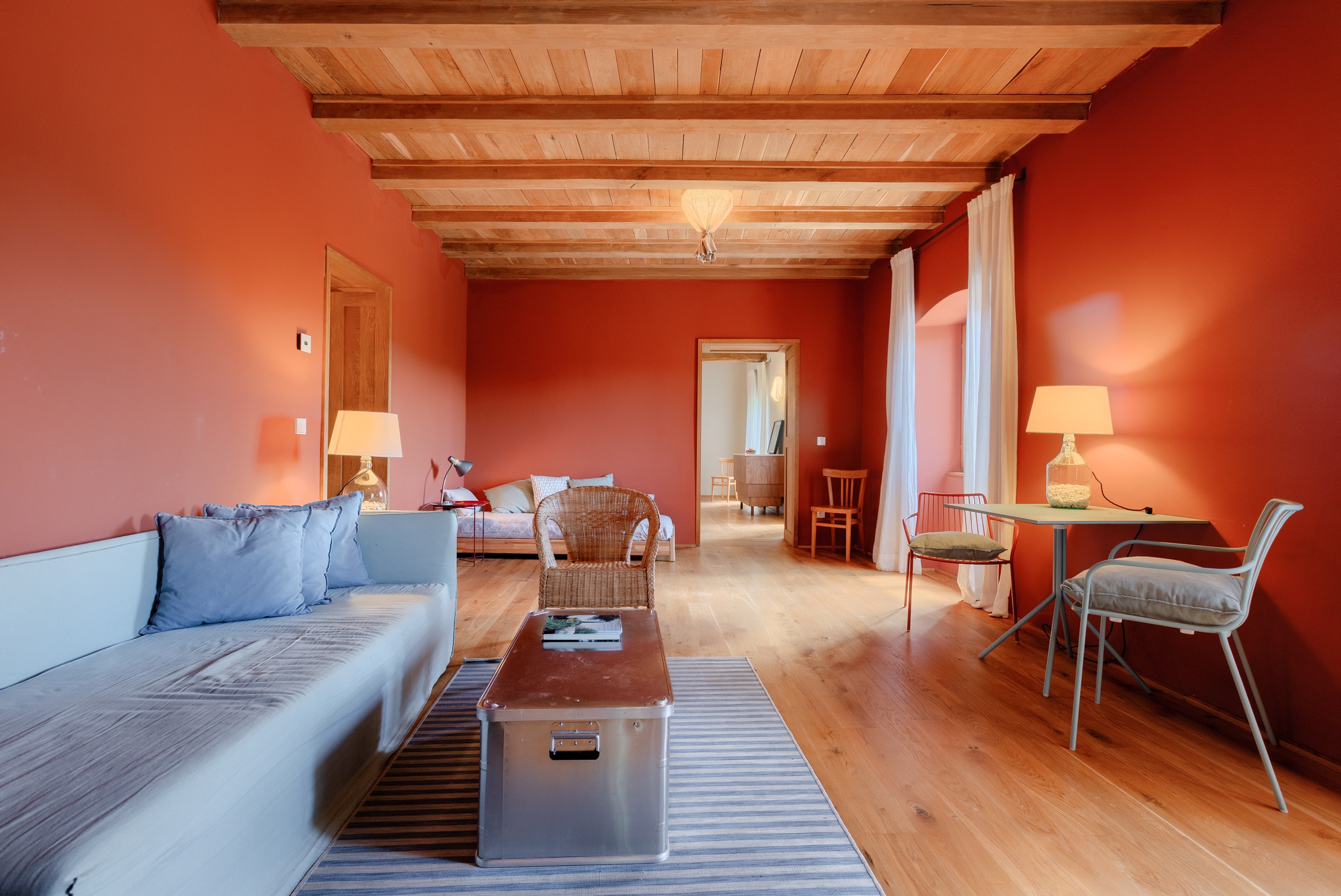 casa ceppi istria croatia interior red living room wooden beams sofa trunk coffee table