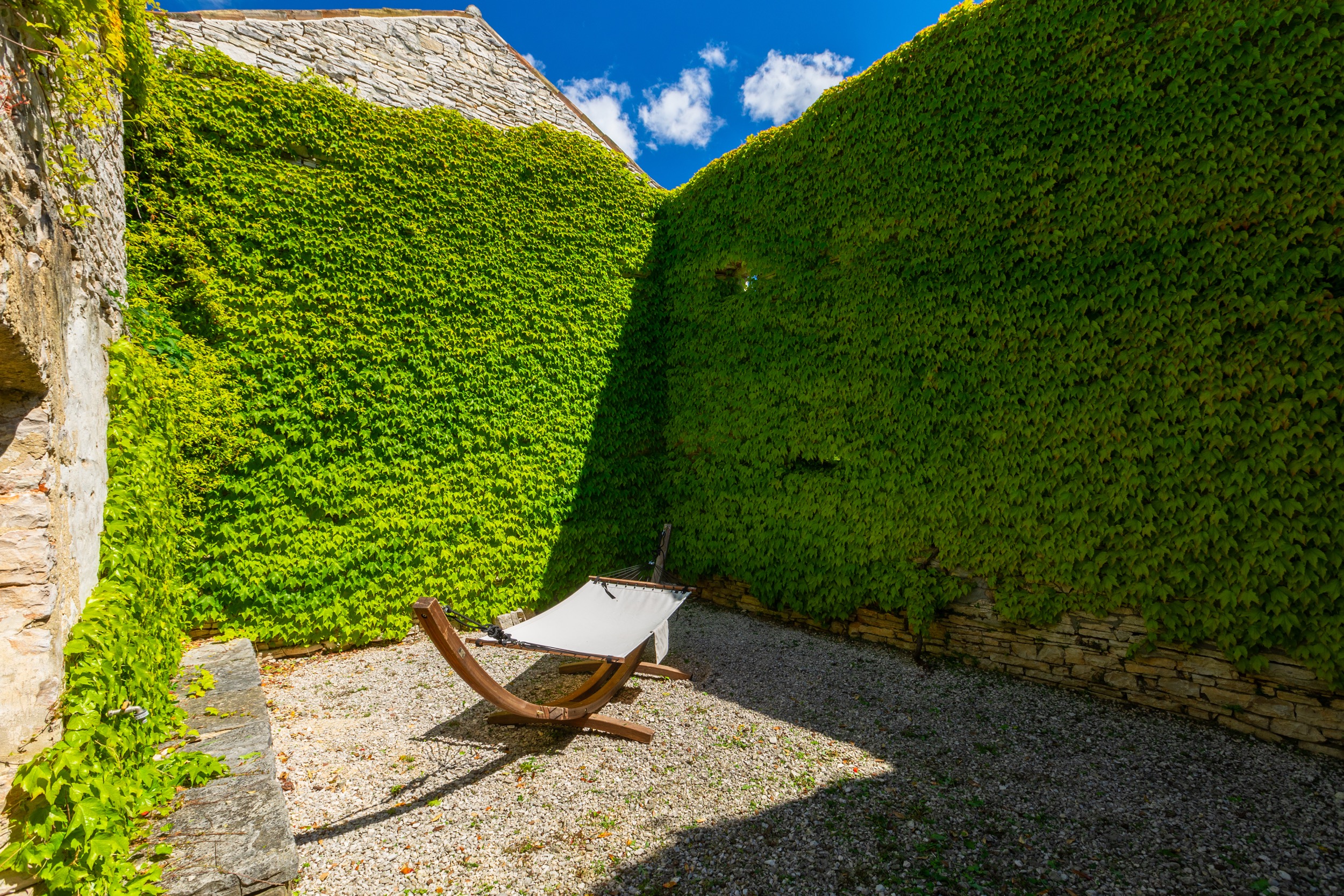 casa ceppi istria croatia ivy covered courtyard hammock stone walls