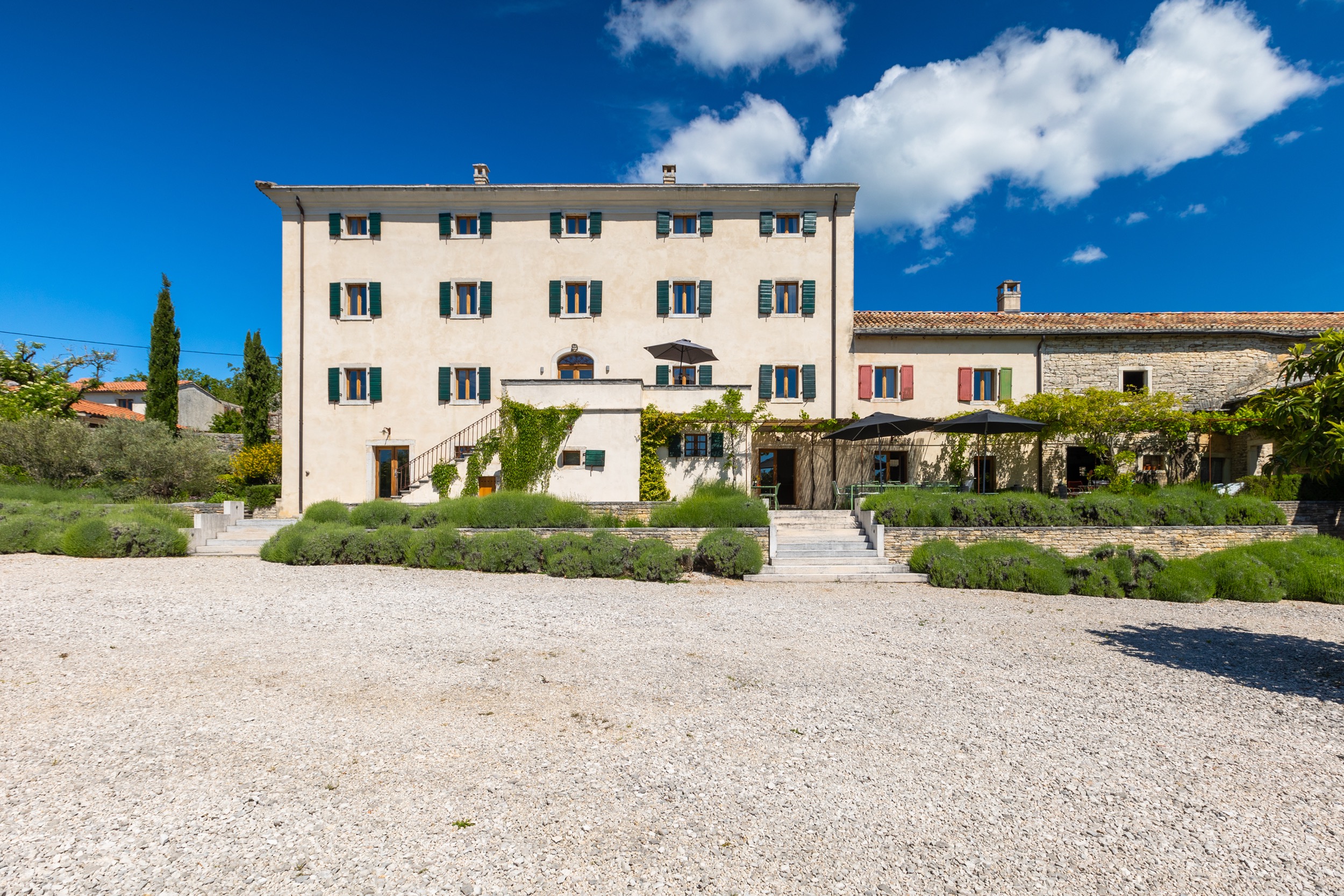 casa ceppi istria croatia main house front facade wide view gravel forecourt lavender beds