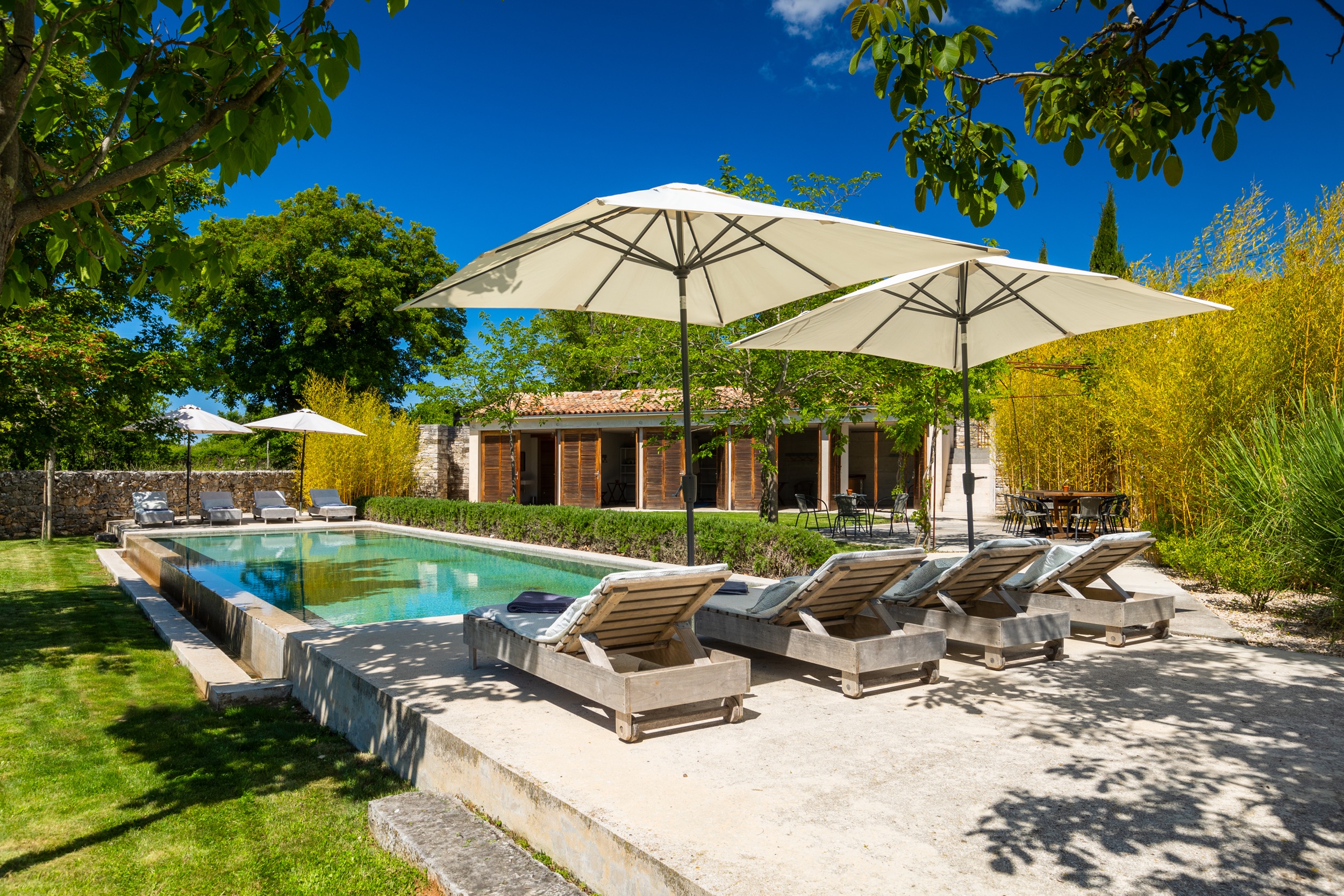 casa ceppi istria croatia outdoor swimming pool lounge chairs umbrellas poolhouse