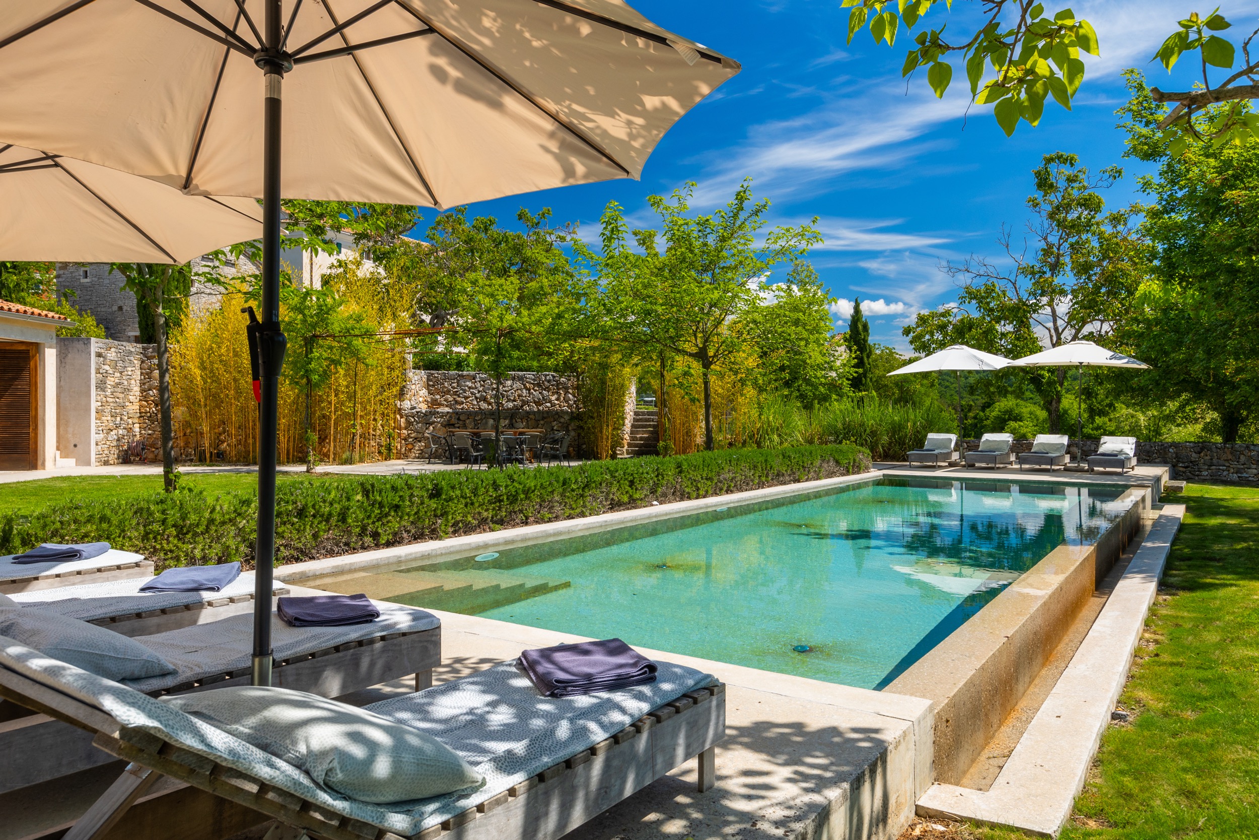 casa ceppi istria croatia pool loungers bamboo hedge folded towels