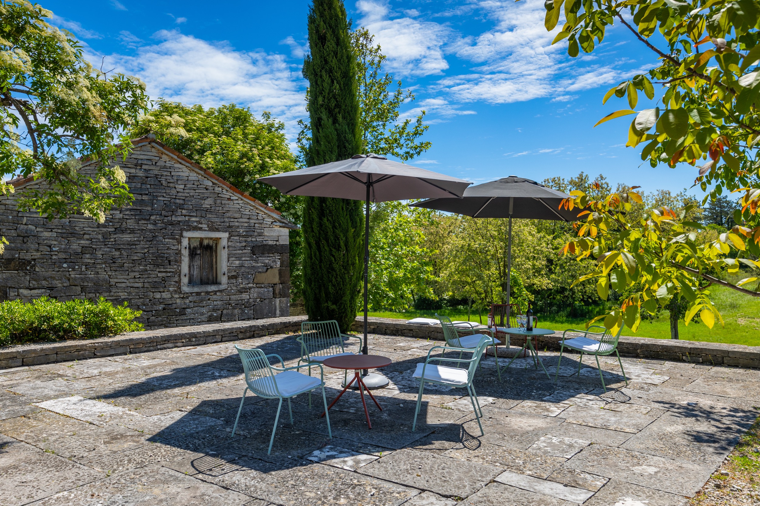 casa ceppi istria croatia sunny terrace cypress tree outdoor table umbrellas